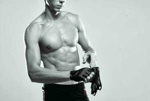 male athlete in sports gloves pumped up press workout fitness photo