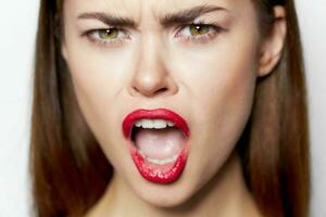 Emotional woman with open mouth face close up studio photo