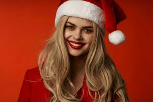 pretty woman in santa hat smile cosmetics glamor red background photo