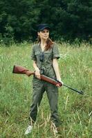 Woman on outdoor Holds a weapon in a green jumpsuit fresh air weapons photo