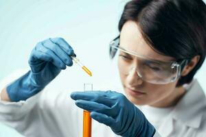 female laboratory assistant in white coat chemical solution test tube science photo