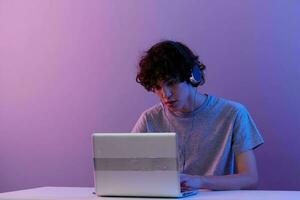 guy cyberspace playing with headphones in front of a laptop isolated background photo