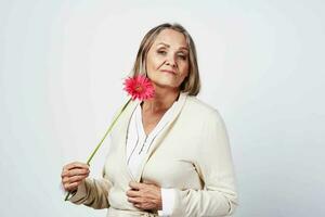 elderly woman holding a flower birthday holiday gift photo