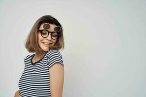 woman in striped t-shirt fashion glasses studio posing photo