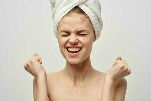 pretty woman with a towel on my head dermatology isolated background photo