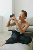 Happy smile woman holding an old camera and taking pictures of herself as a weekend photographer in home clothes with a short haircut hair without filters on a white background, free copy space photo