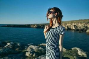 woman in sunglasses outdoors summer landscape sea fresh air photo