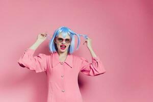 glamorous woman in sunglasses wears a blue wig makeup isolated background photo