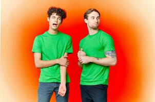 two friends cover their hand face emotions displeasure red background photo