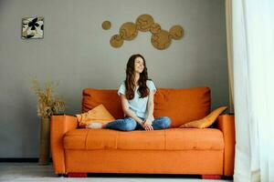 portrait of a woman relaxing at home in the room on the couch interior Lifestyle photo