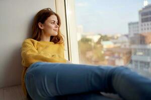 beautiful woman lies near the window dreamy look photo