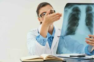 Doctor sits at the table x-ray picture radiologist research photo