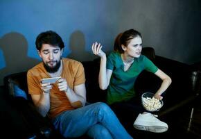 emotional man and woman watching tv indoors photo
