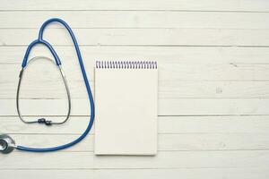 Stethoscope notepad medicine treatment top view photo