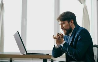 man in suit in front of laptop office manager finance photo