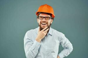 Cheerful man in orange hard hat shirt gesturing with hands work construction engineer photo