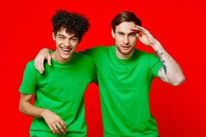 Cheerful friends in green t-shirts hugs communication positive photo
