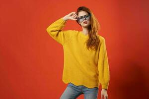 woman in yellow sweater posing blue glasses fashion photo