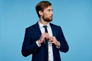 man in a suit straightens his tie self confidence fashion businessman photo