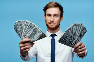 business man shirts wads of money wealth emotions blue background photo