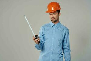 man in construction uniform blueprints builder light background photo