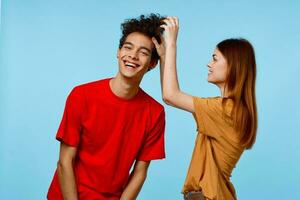 Cheerful guy and girl in multicolored T-shirts emotions joy of communication photo