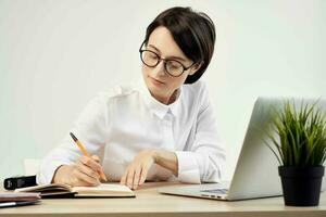 Businesswoman at the desk with glasses self-confidence isolated background photo