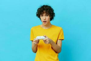 guy yellow T-shirt with joystick video games isolated backgrounds photo