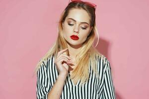 pretty blonde in striped shirt pink glasses glamor isolated background photo