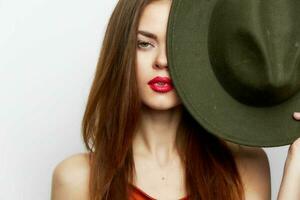 Woman holding hat near face Charm model studio evening makeup photo