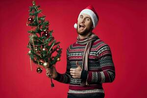 man with christmas tree toys holiday decoration red background photo