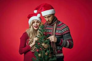 man and woman in new year clothes together holiday gifts red background photo