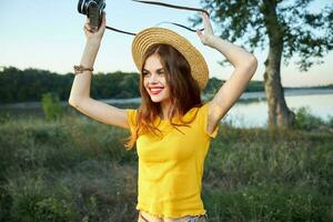 Cheerful female photographer looking aside red lips hat fresh air travel photo