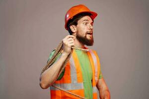 Male builder orange hard hat work Professional gray background photo