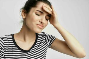 brunette in a striped t-shirt pain in the neck health problems photo