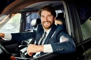 businessmen in a suit in a car a trip to work service photo