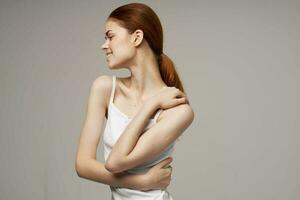 woman kneads shoulders and back joint pain photo