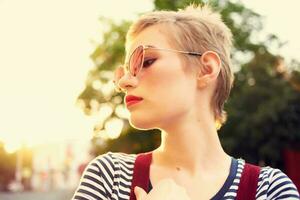 woman wearing sunglasses outdoors walk emotions fashion posing photo