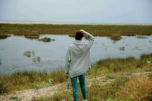 woman admire nature walk behind photo