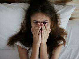 crying woman lying in bed temperature upset photo