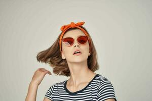 emotional woman wearing sunglasses in striped t-shirt posing fashion photo