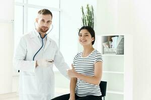 male doctor next to patient good treatment hospital photo