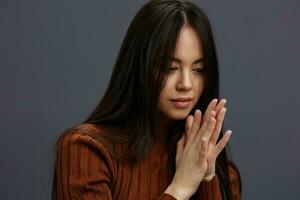 young woman hand gestures brown sweater fashion studio model photo