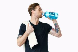 athletic man drinking water energy workout towel on shoulder photo