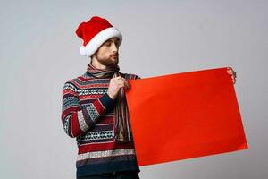 handsome man in New Year's clothes holding a banner holiday isolated background photo