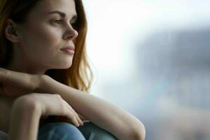 woman sitting on the windowsill with a blue plaid dreamy look photo