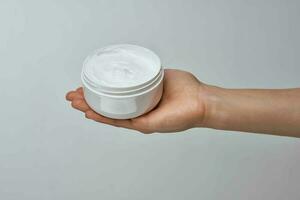 cream in female hands moisturizing dermatology skin care photo