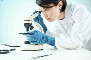 female laboratory assistant microscope research biotechnology nothing photo