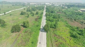 aerial view of highway between trees and green open space video