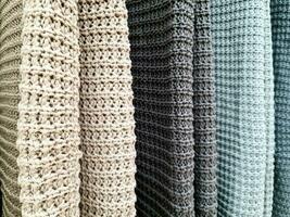 Detailed close up view on samples of cloth and fabrics in different colors found at a fabrics market photo